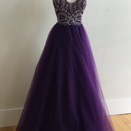 A Long Gown Of A Purple Beaded Ball Gown With A..