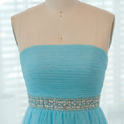 A Strapless Long Blue Dress With Pleated Bodice..
